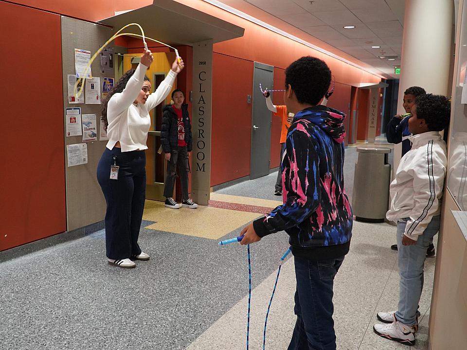 Austen Ivey leads a group of students through a jump rope activity at the November Saturday Academy